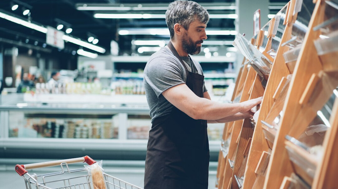 man in supermarket uniform